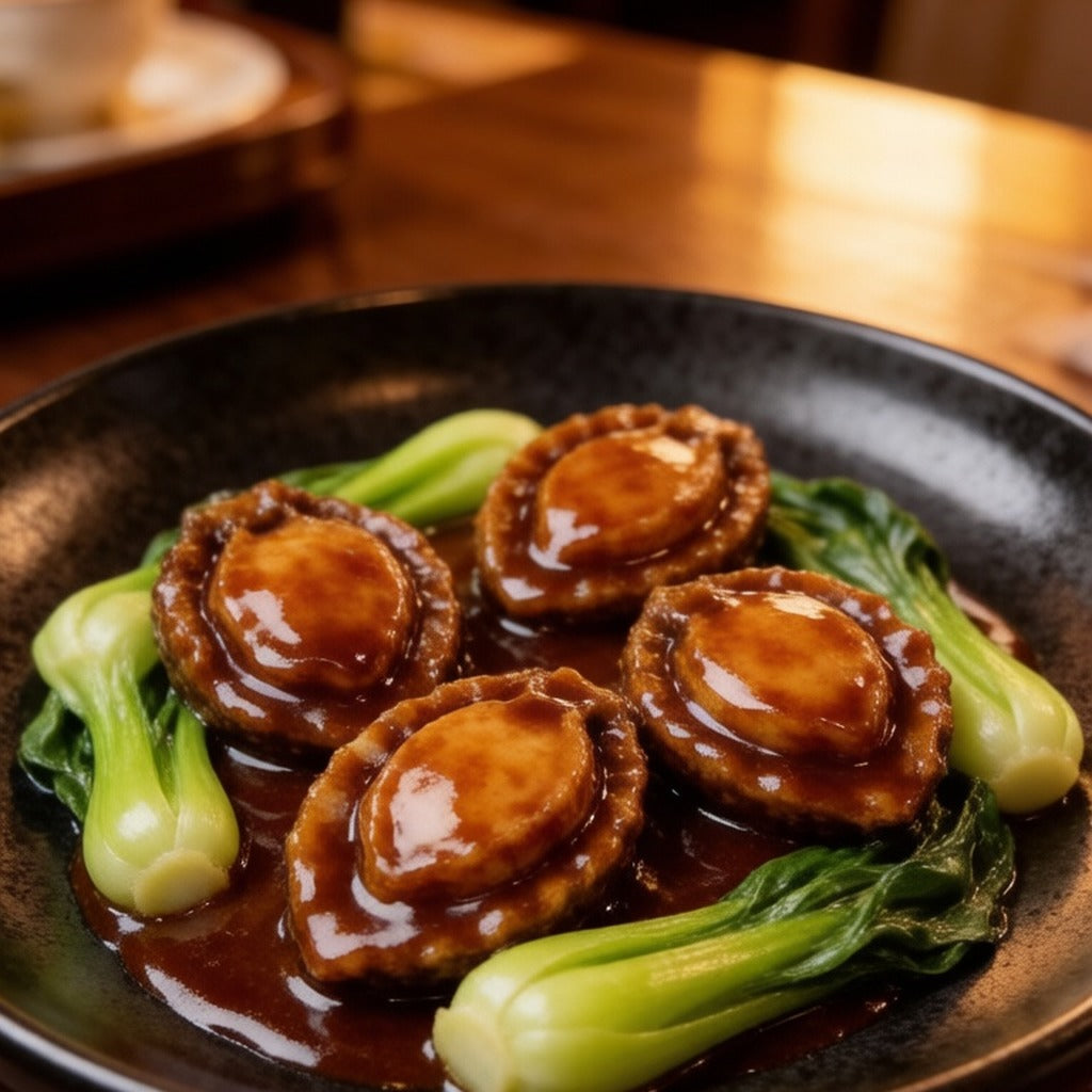 Braised abalone served with bok choy in a glossy sauce