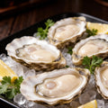 Half-shell oysters on crushed ice with lemon and parsley