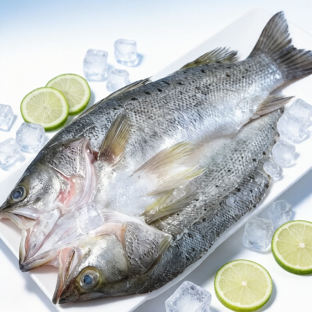 Whole white fish laid on crushed ice with lime halves